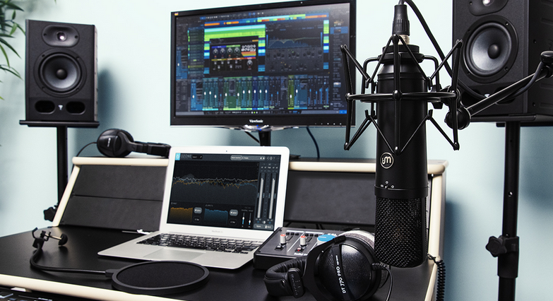 An Image with studio recording gear , microphones , laptop , mixer ,speaker ,headphones 